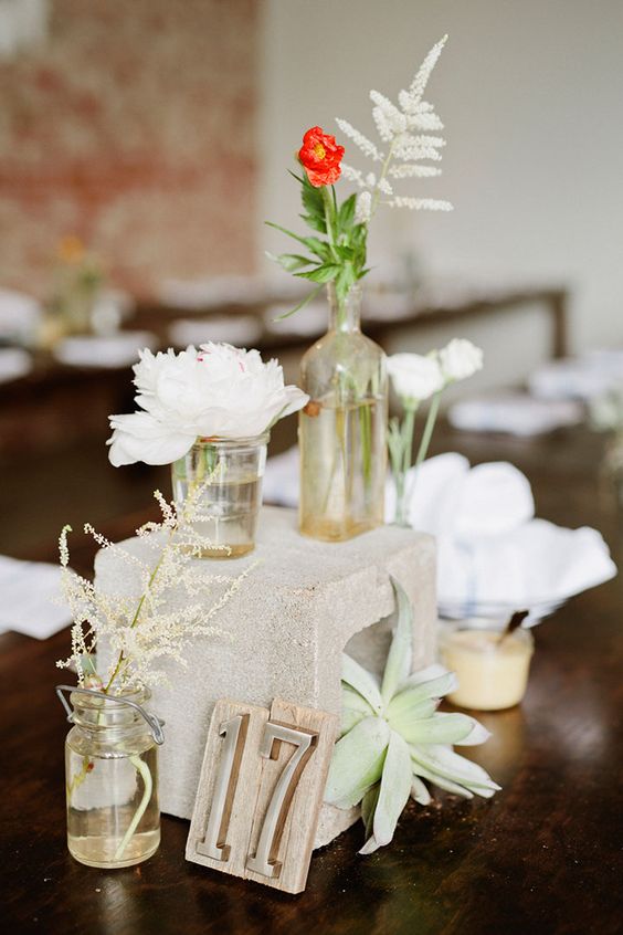 Concrete block wedding centerpieces with vintage bottle vases