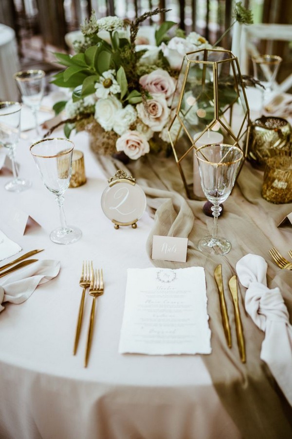 Geometric candle holders, gold cutlery, and pink blooms