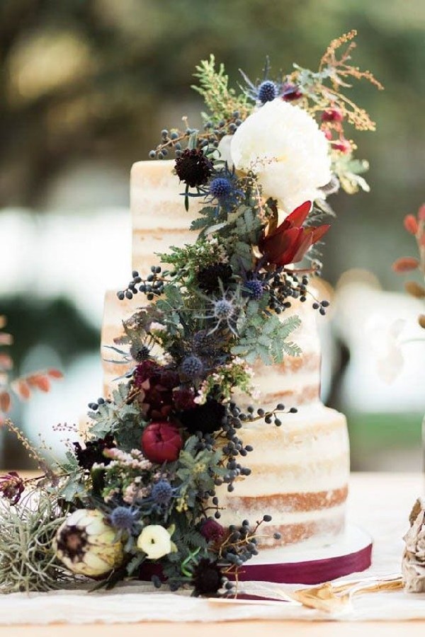 naked wedding cake paired with a dark color palette floral arrangement
