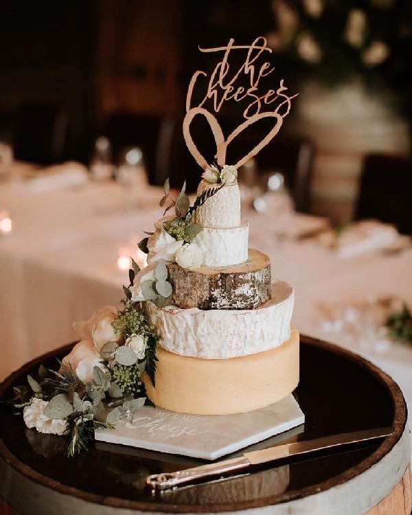 neutral cheese wedding cake with green flowers