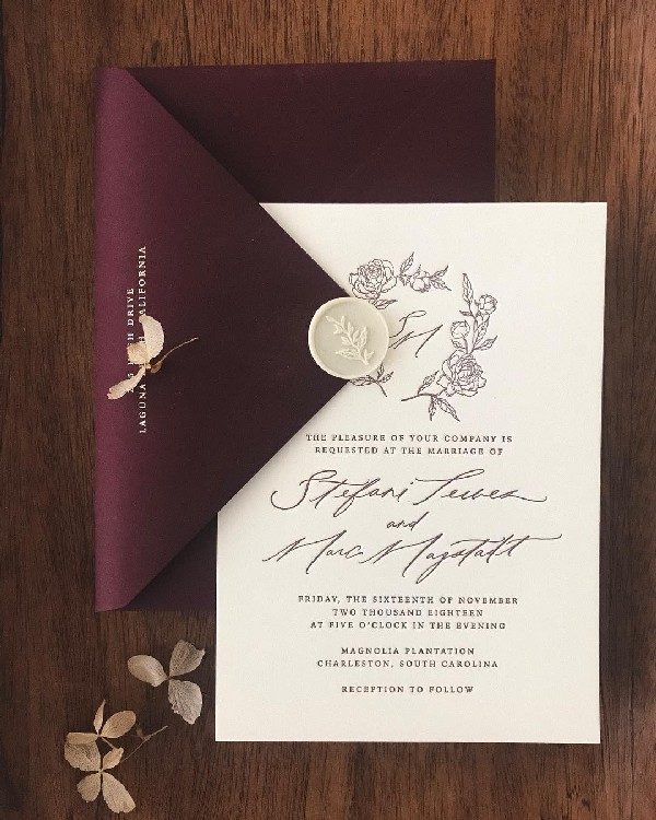 vintage ivory wedding invitation with burgundy envelope