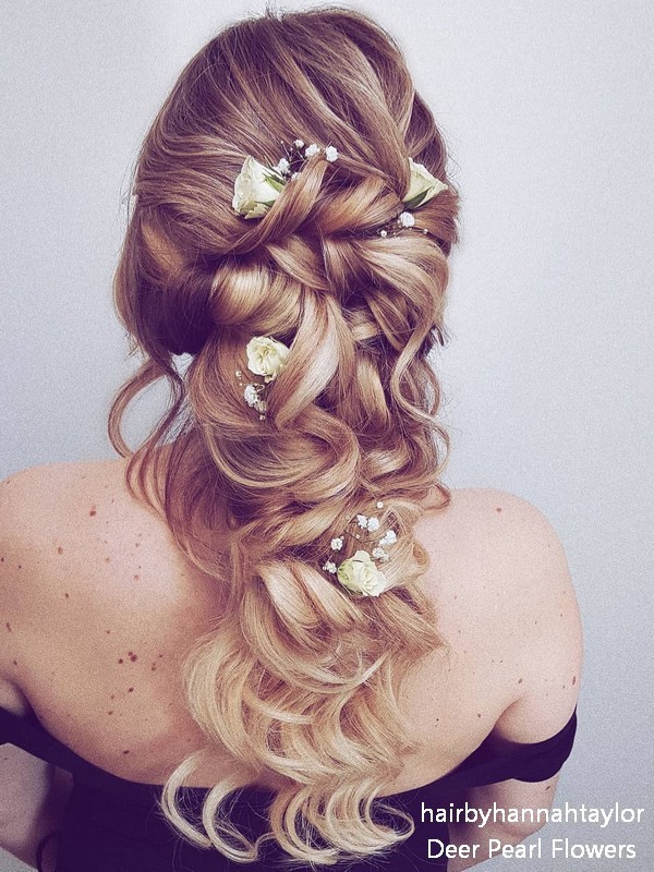 long half up half down wedding guest hairstyle with flowers