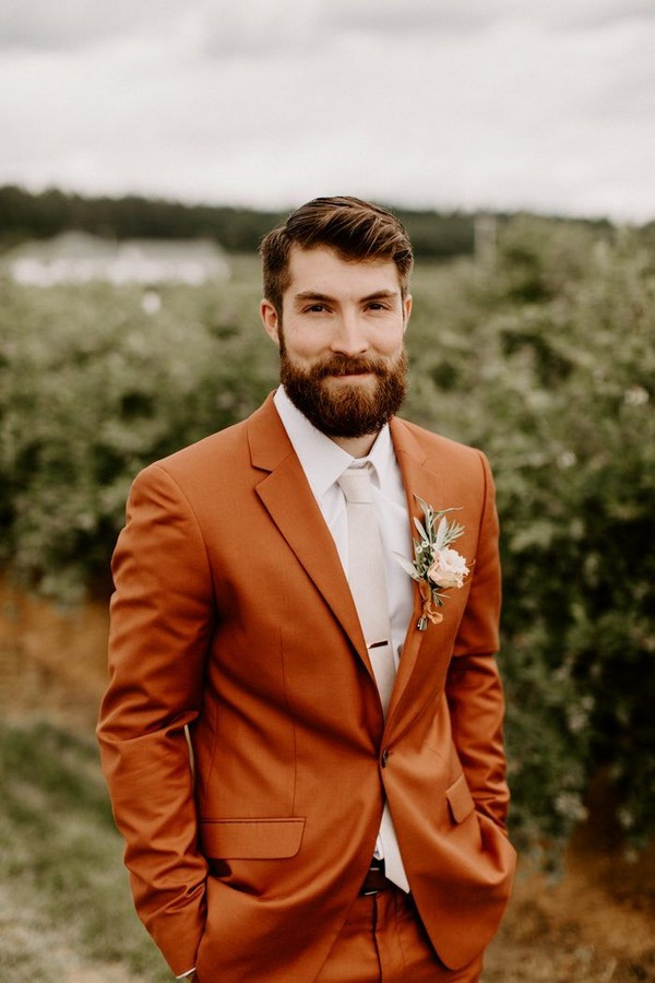 groom went for a non-traditional look with a stunning rust-colored suit