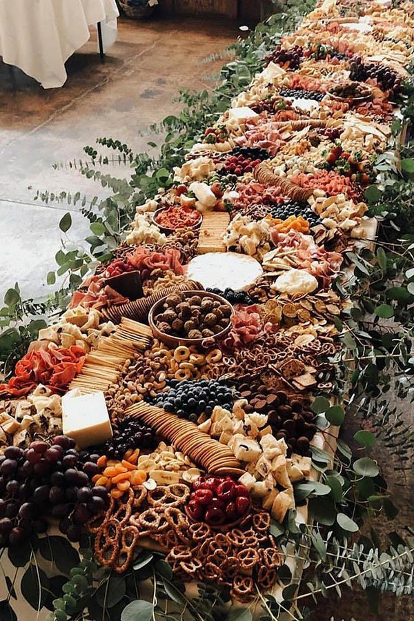 rust wedding color long catering table decorated with greenery
