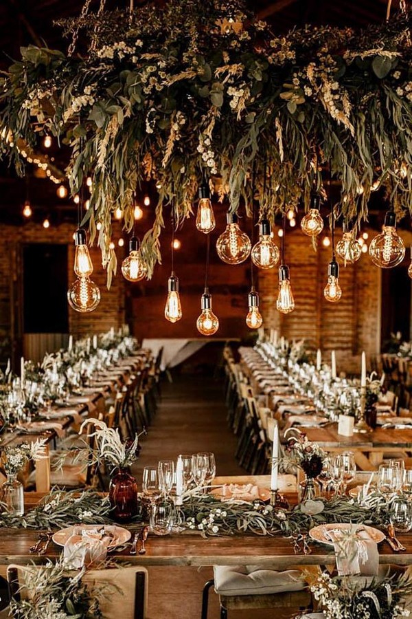 rust wedding color reception in barn with greenery and hanging lights chrisandruth