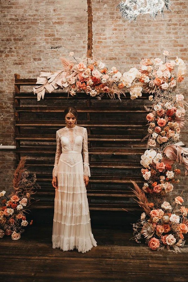 rust wedding color wooden pallette backdrop with roses and pampas grass 