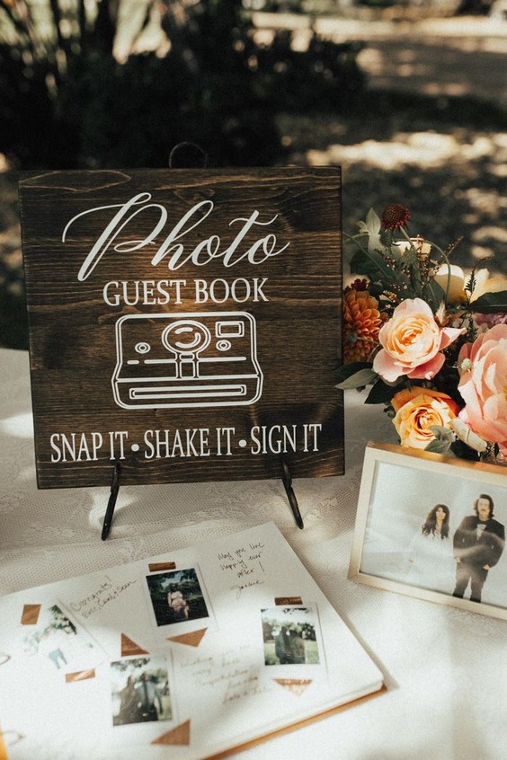 Adorable rustic signage featured at this summery guest book table