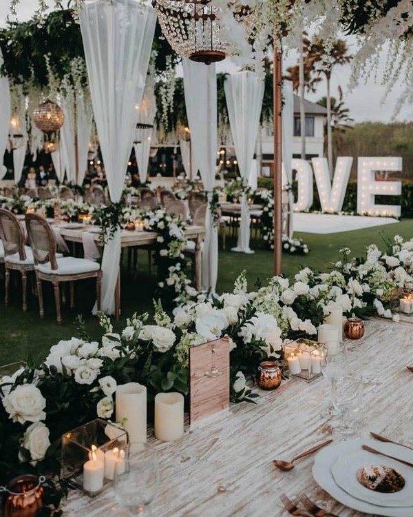 outdoor greenery and white wedding reception decor