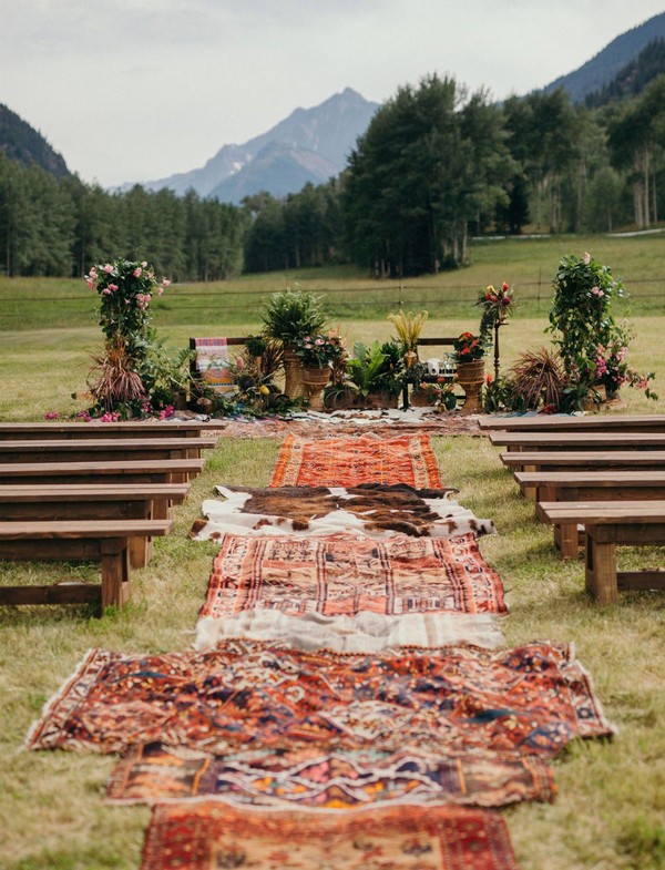Boho Glam Aspen Wedding with rugs lining the ceremony aisle