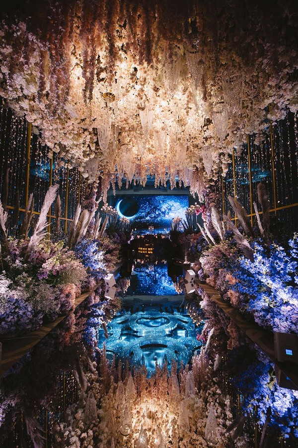 Lush hanging floral arrangements flowers and mirrored aisle
