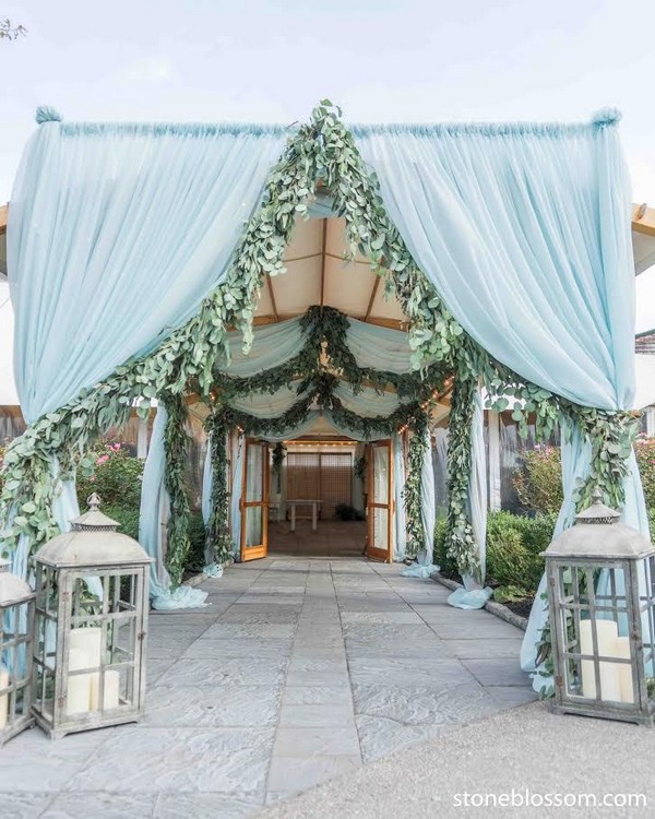 blue draping and greenery rustic lanterns wedding reception entrance