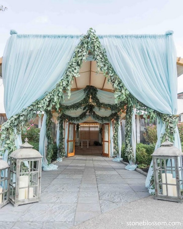 blue draping and greenery rustic lanterns wedding reception entrance