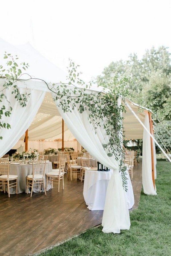 chic elegant tented wedding reception with greenery