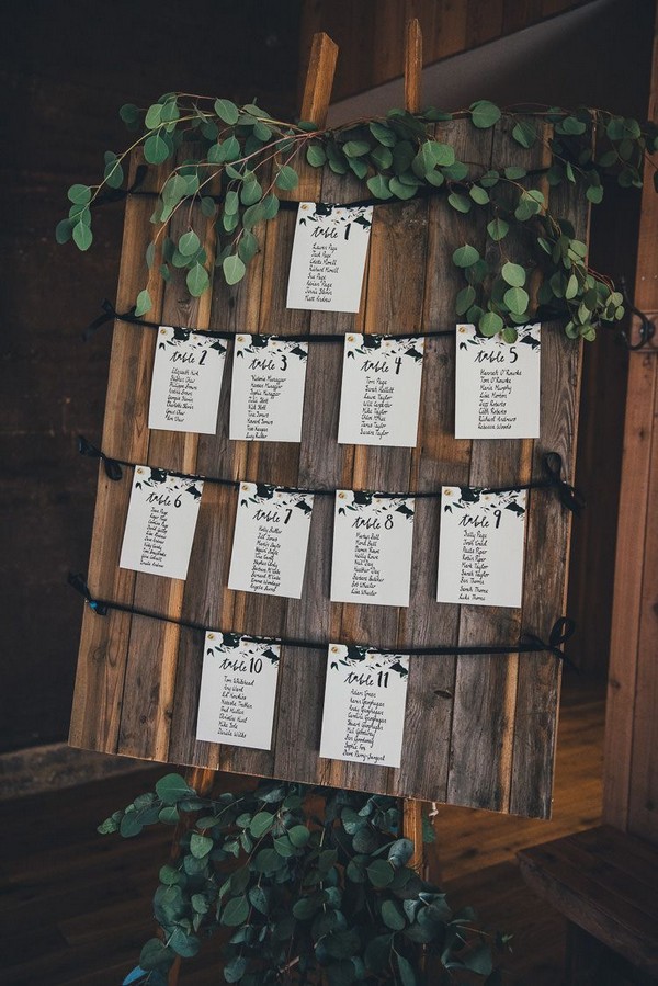 rustic wooden wedding seating chart with eucalyptus