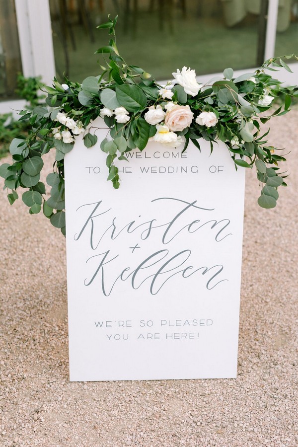 White wood sandwich board welcome sign for a chic summer garden wedding
