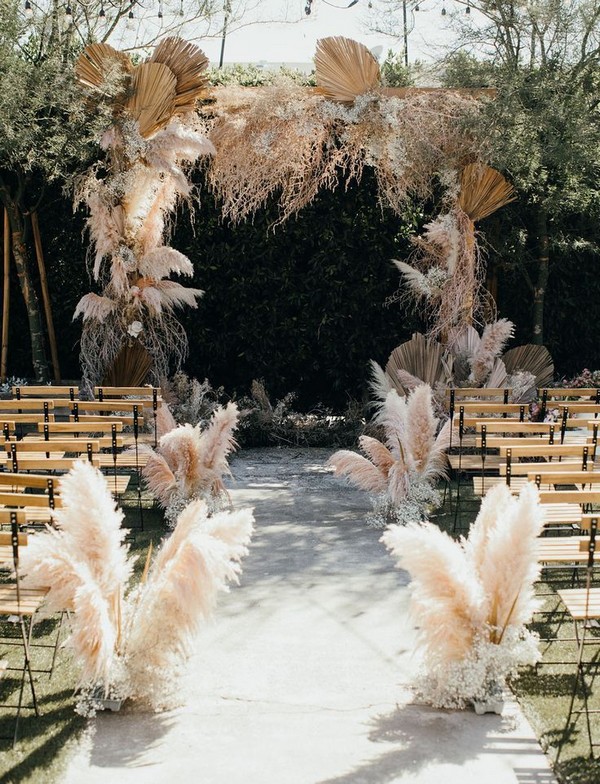 fall bobo coloured pampas grass and tropical preserved leaves wedding ceremony arch