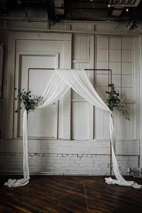 minimalist wedding decor botanical greenery arch with white cloth ohio wedding