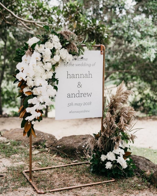 white roses and pampas grass wedding welcome sign