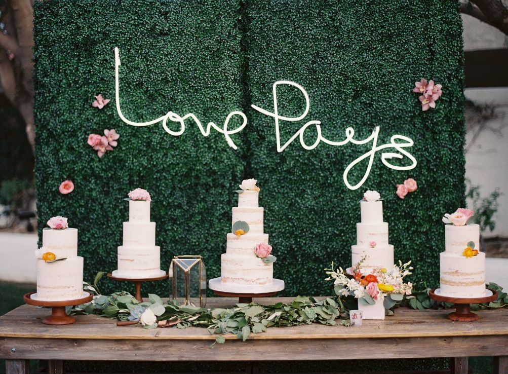 Bohemian Cake Table with Flower Wall and Neon Sign