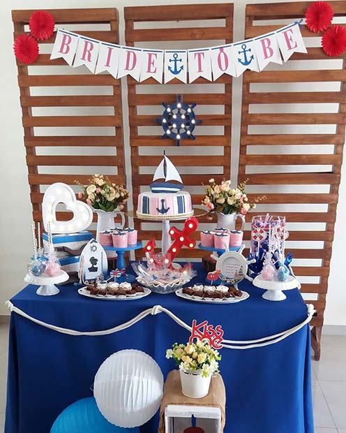 nautical bridal shower dessert table with a banner some nautical decor an anchor marquee light and tasty desserts