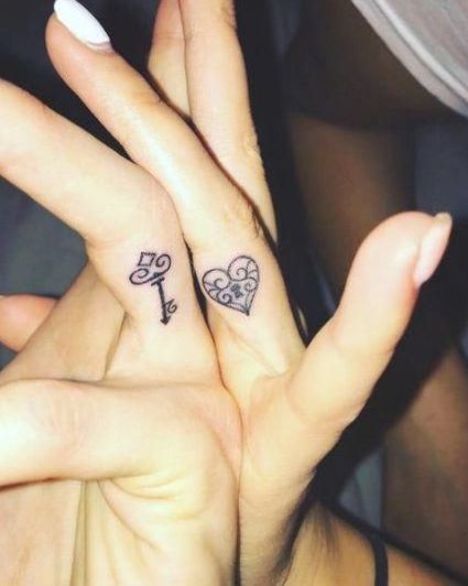 Matching lock and key finger tattoos