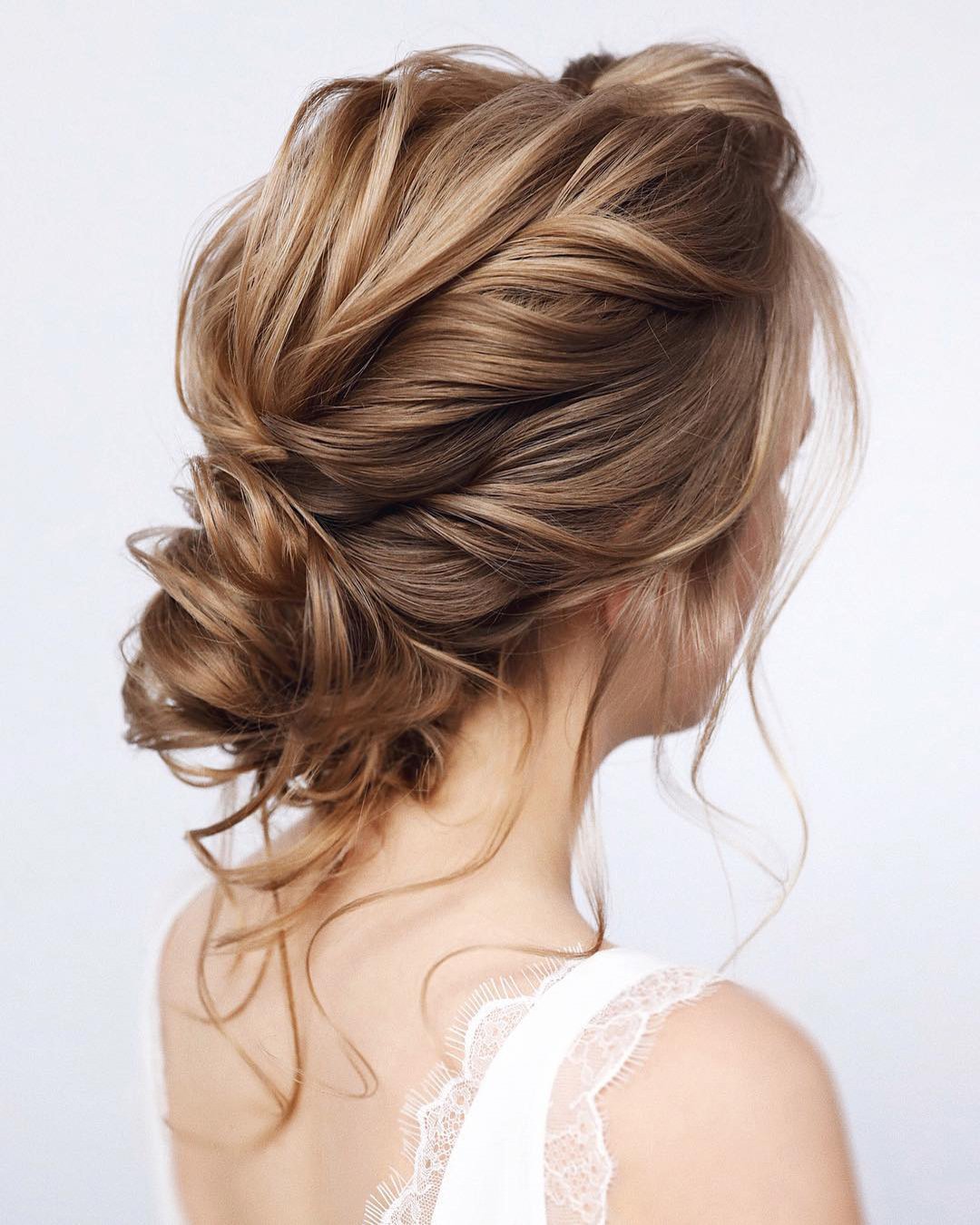 wedding hairstyles for medium hair low curly bun with loose curls