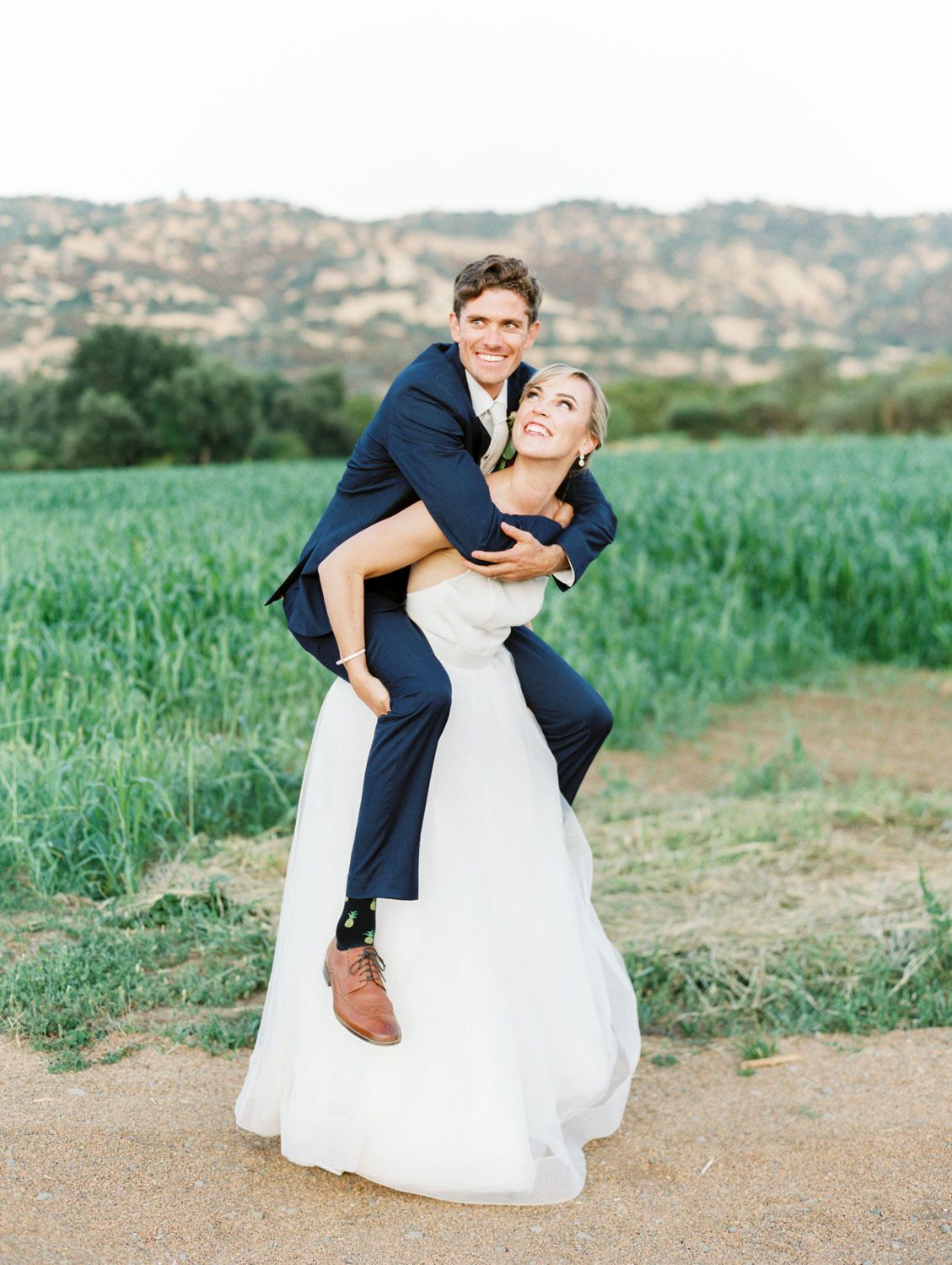 piggy back ride wedding photo