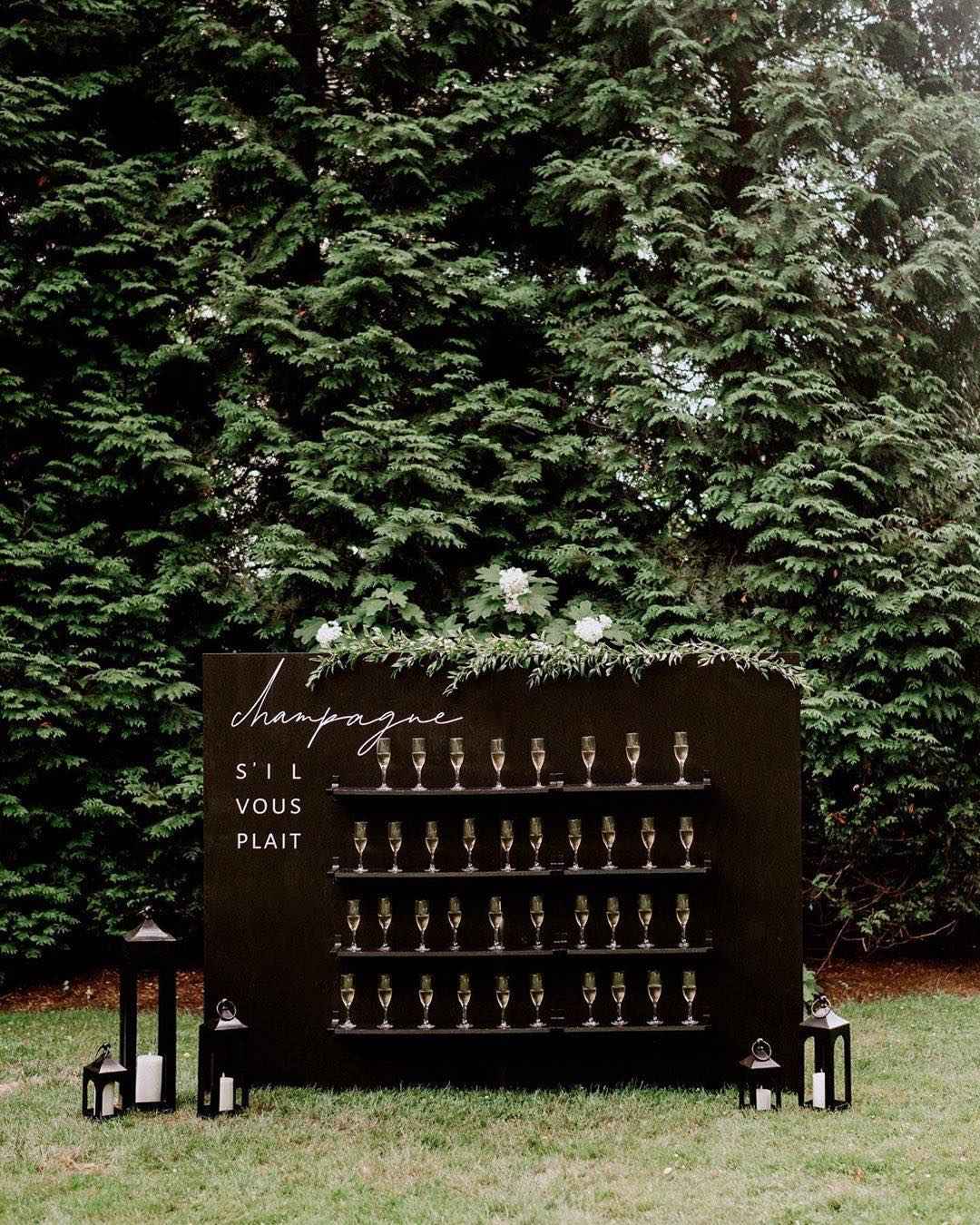 black champagne wedding wall with greenery