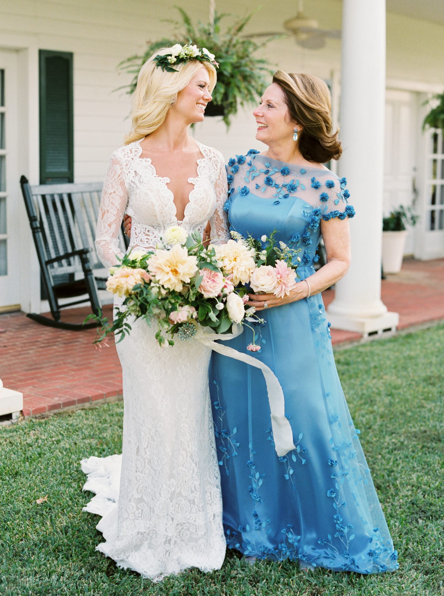 Mother of the Bride wear blue flower dress and the bridal wear a long sleeves wedding dress