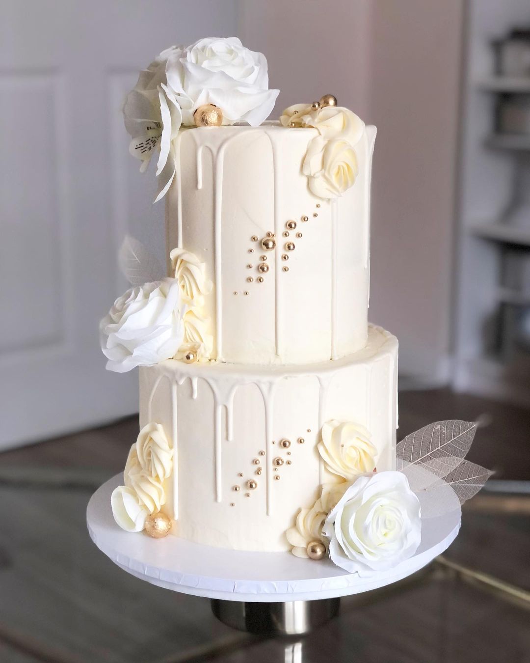2 tier drip white and gold wedding cake via amelias__cakes