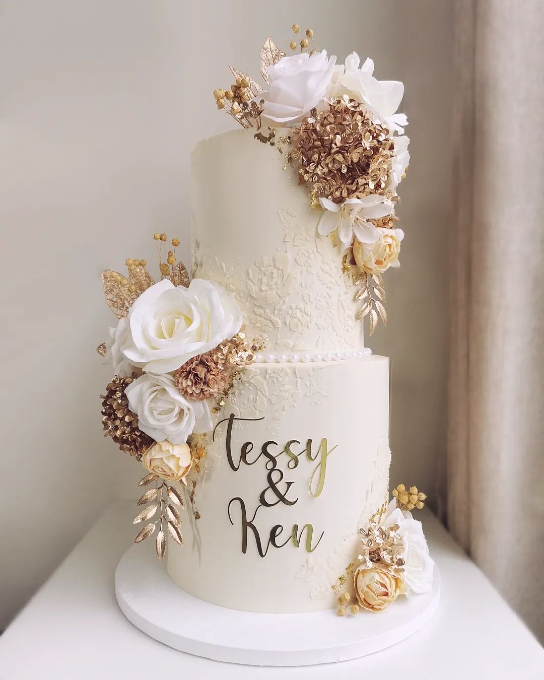 2 tier modern white wedding cake with gold mirror name sign via littlemissfattycakes