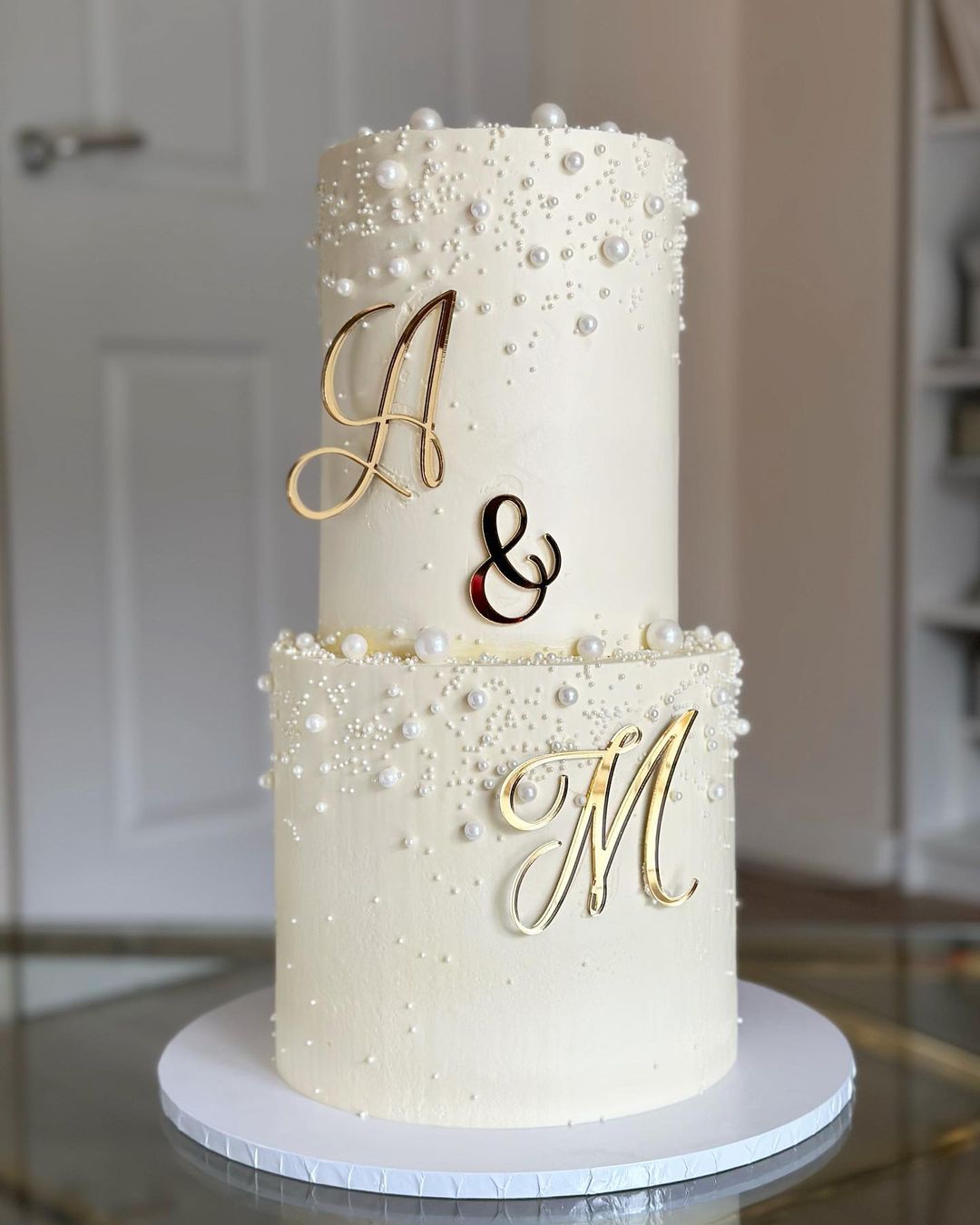 2 tier white pearlwedding cake with gold mirror name sign wedding cake via amelias__cakes