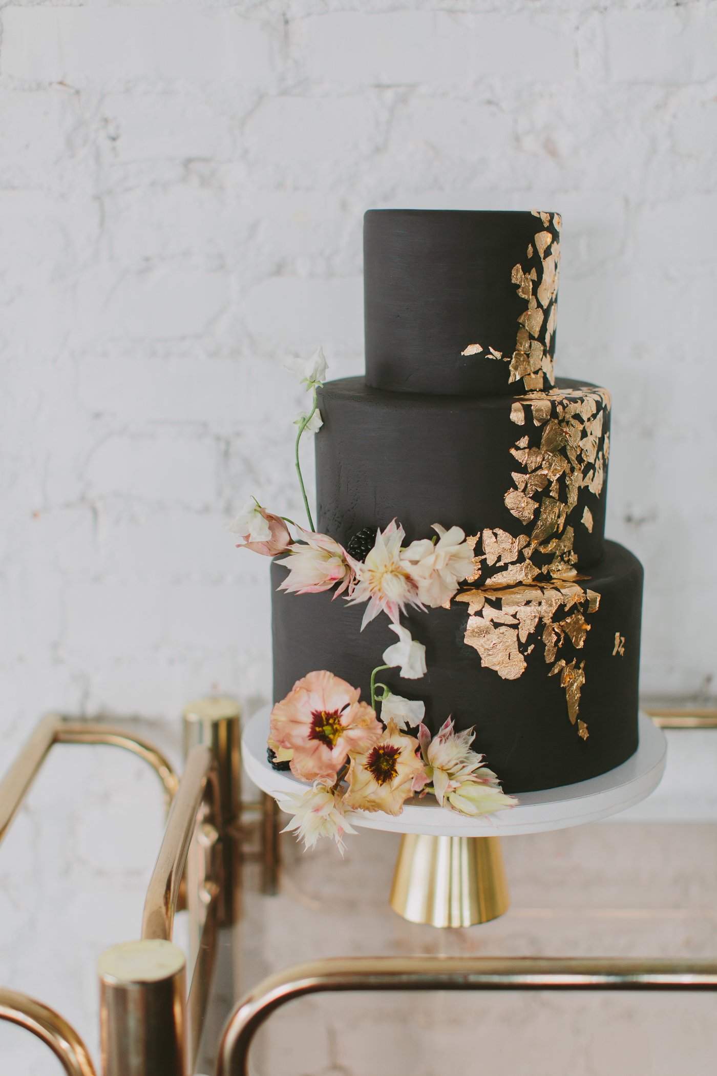 3 tier black wedding cake with rose gold glitter