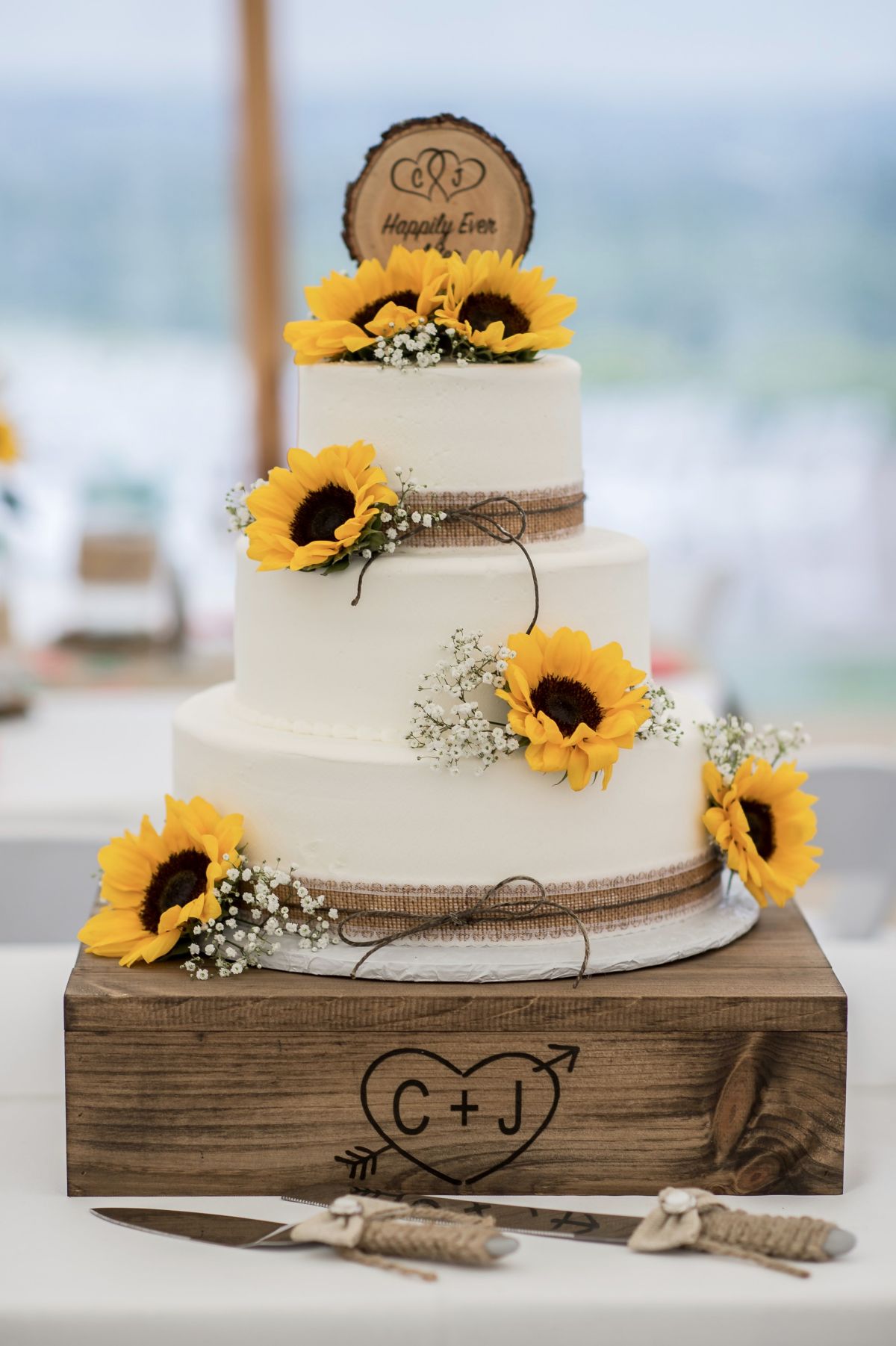 3 tier buttercream country wedding cake with sunflowers and wood cake topper