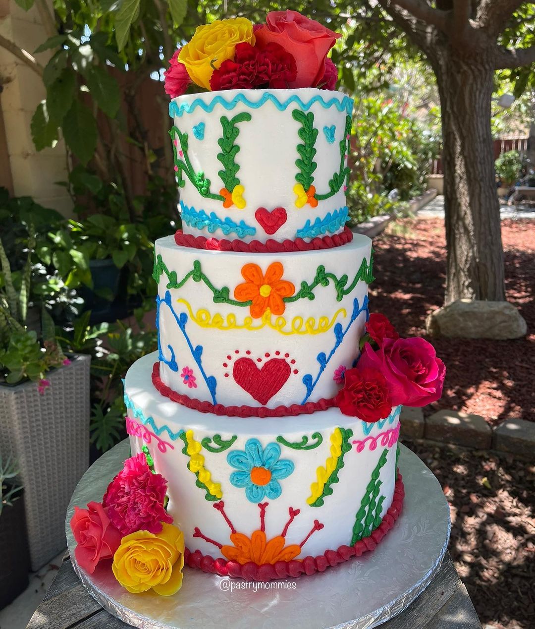 3 tier colorful mexican embroidery wedding cake with red yellow flowers via pastrymommies