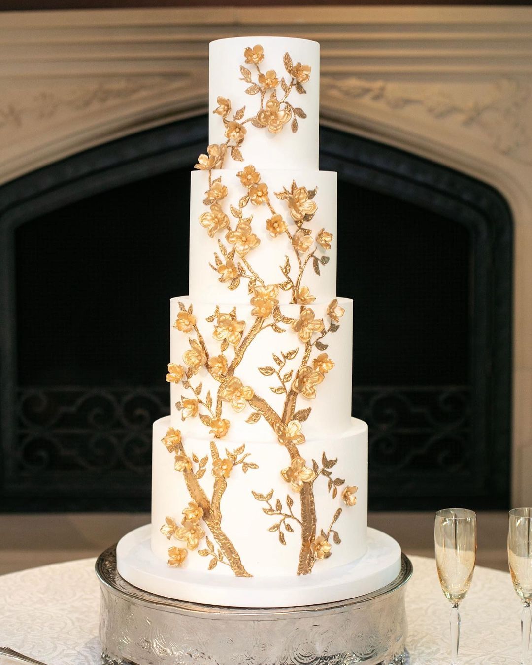 4 tier white wedding cake with gold cherry blossoms via fancycakesbylauren