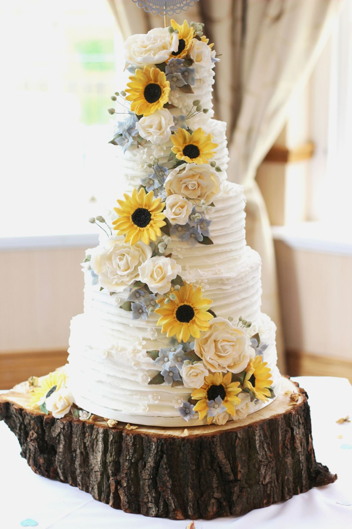 5 tier country butter cream sunflower wedding cake on tree stump