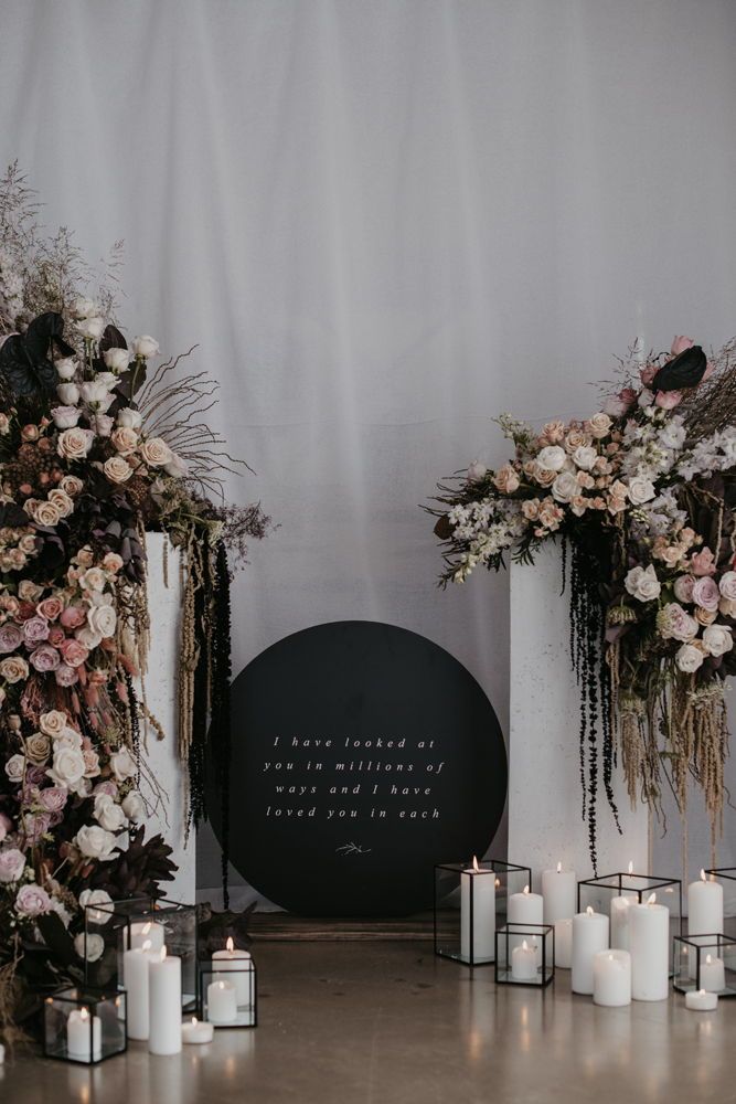 Industrial black and rose gold wedding backdrop with round wedding sign