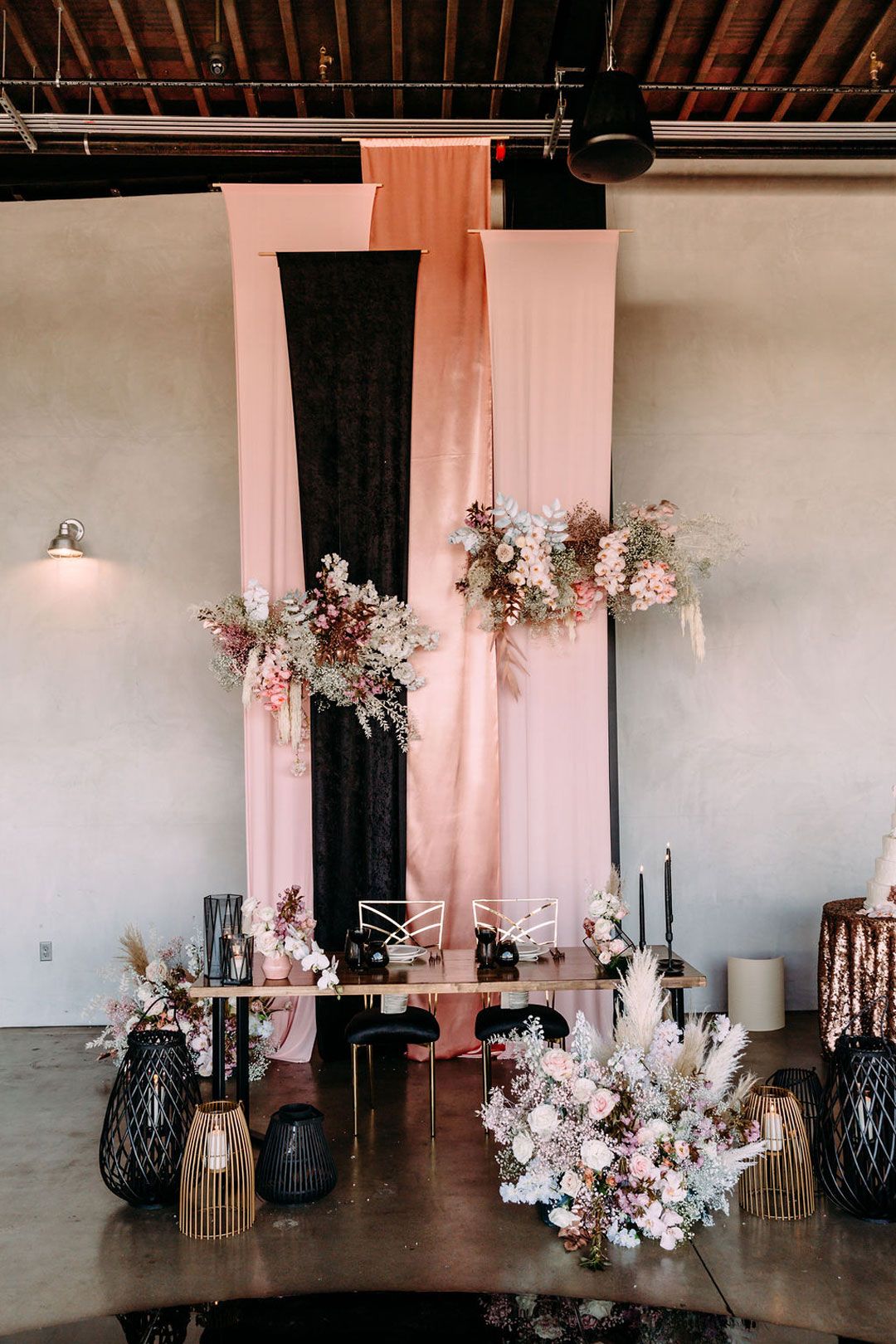 Modern rose gold pink and black sweetheart table and backdrop