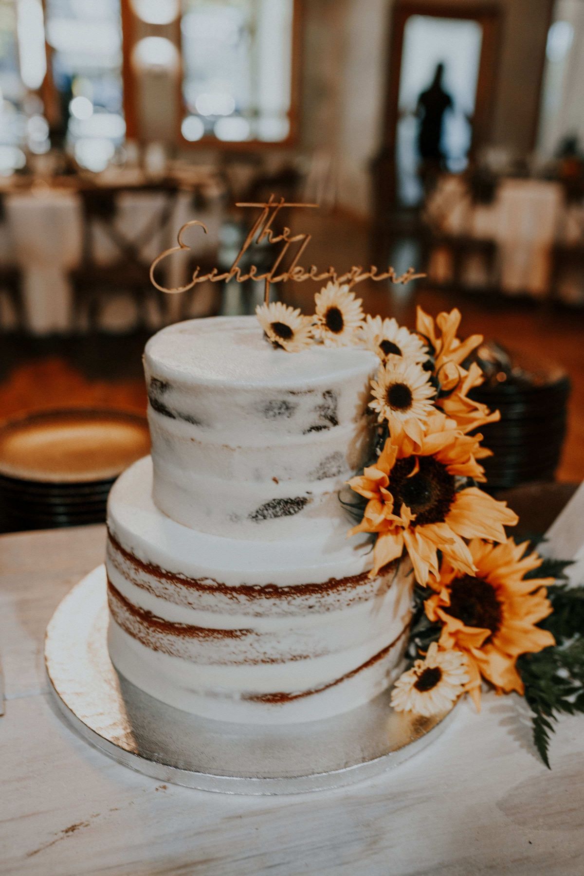 Naked Wedding Cake with Sunflowers and Gold Topper