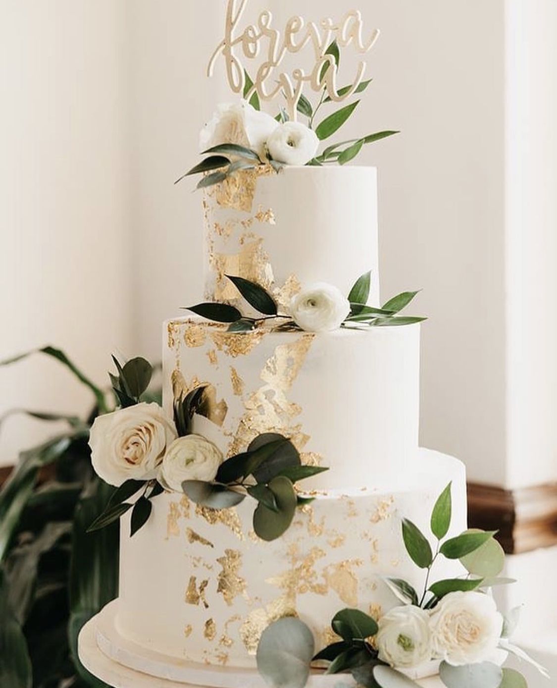 White wedding cake with gold flakes