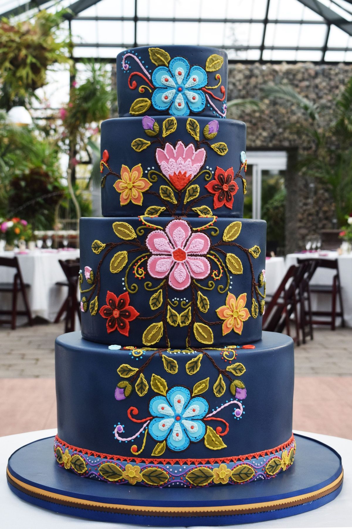black wedding cake with colorful mexican embroidery