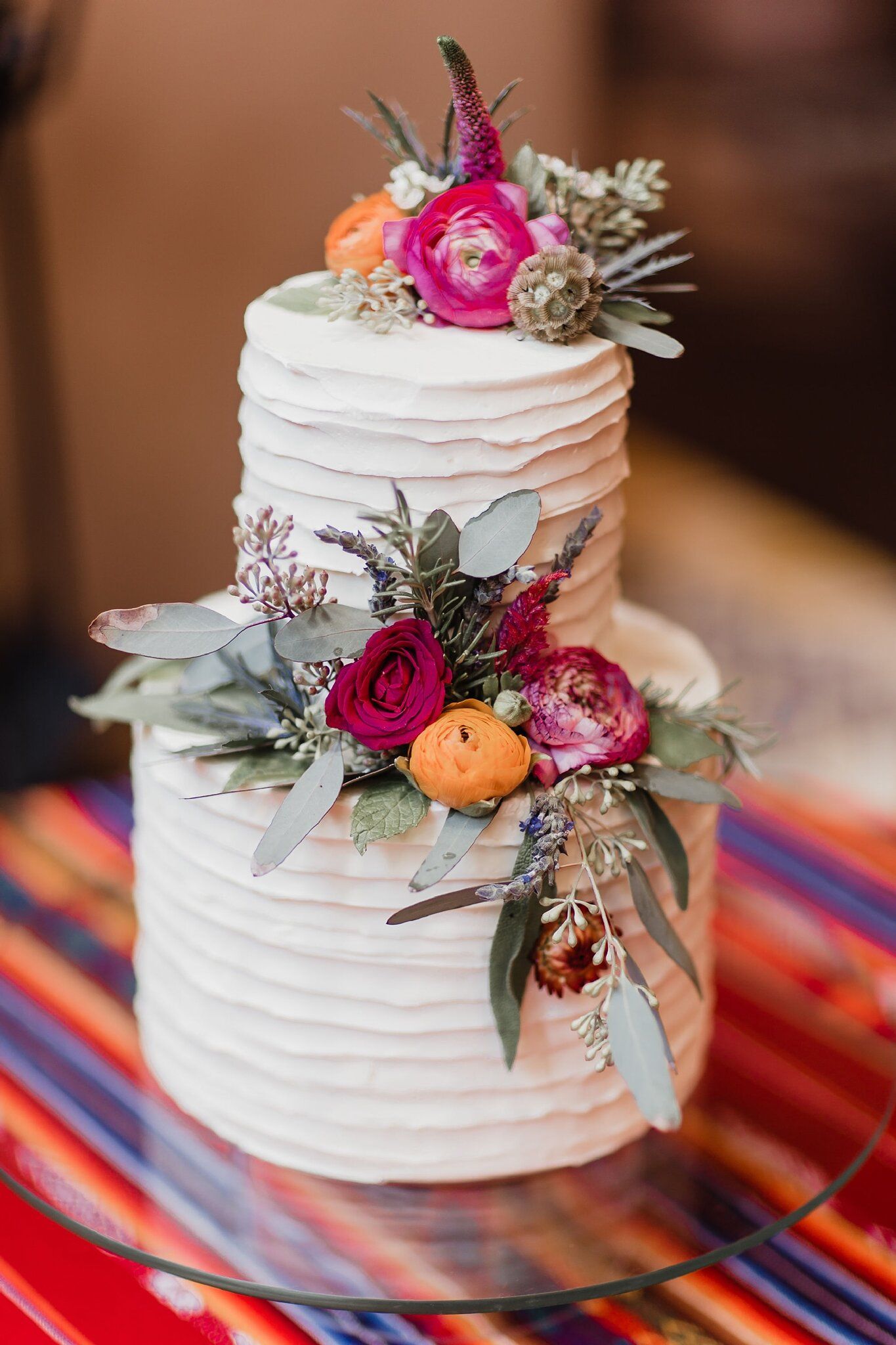buttercream wedding cake with mecian style color flowers