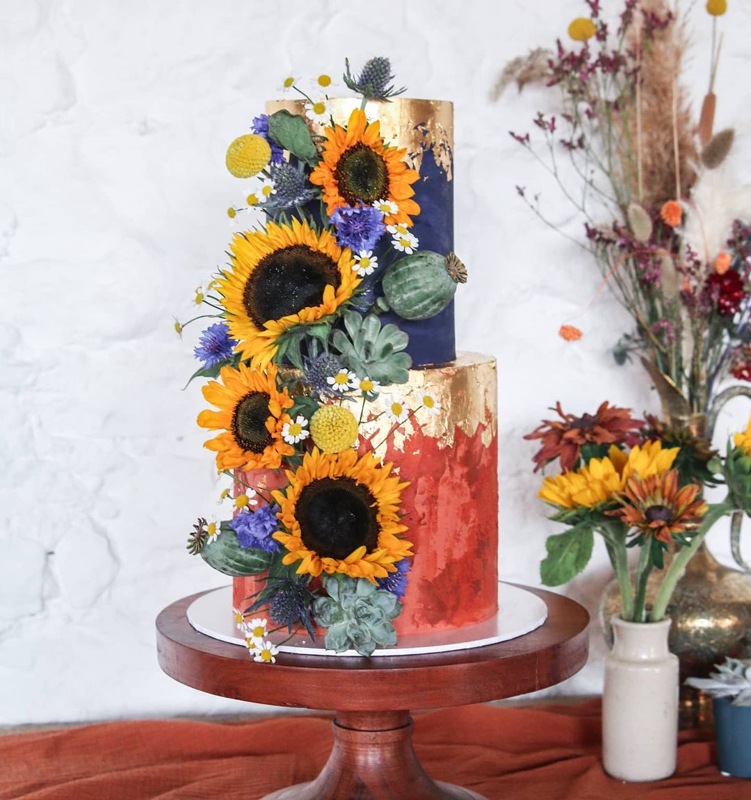 colorful modern red and navy wedding cake with sunflowers sallycoopercakeartist