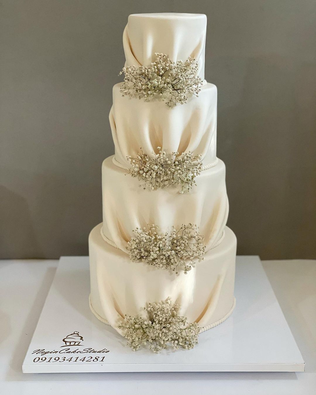 elegant and vintage white 4 tiered wedding cake via negin_cake_studio