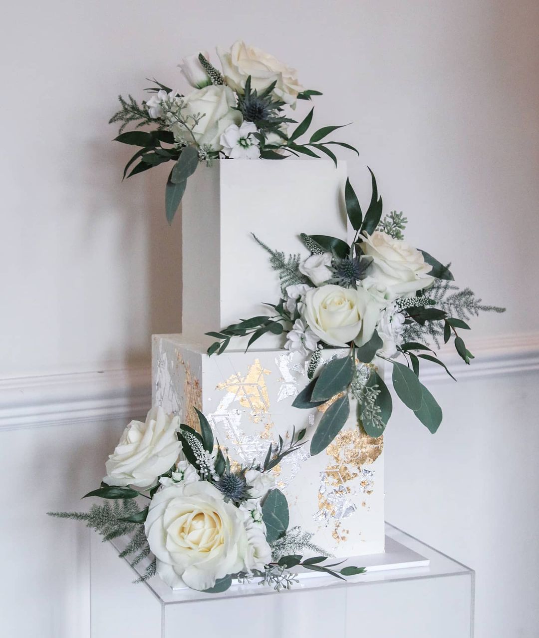 elegant modern square wedding cake with greenery via sallycoopercakeartist