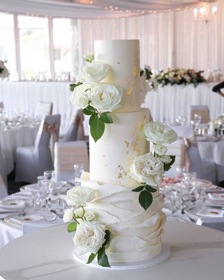 elegant simple white wedding cake with gold foil and roses via milkandhoney.cakecreative
