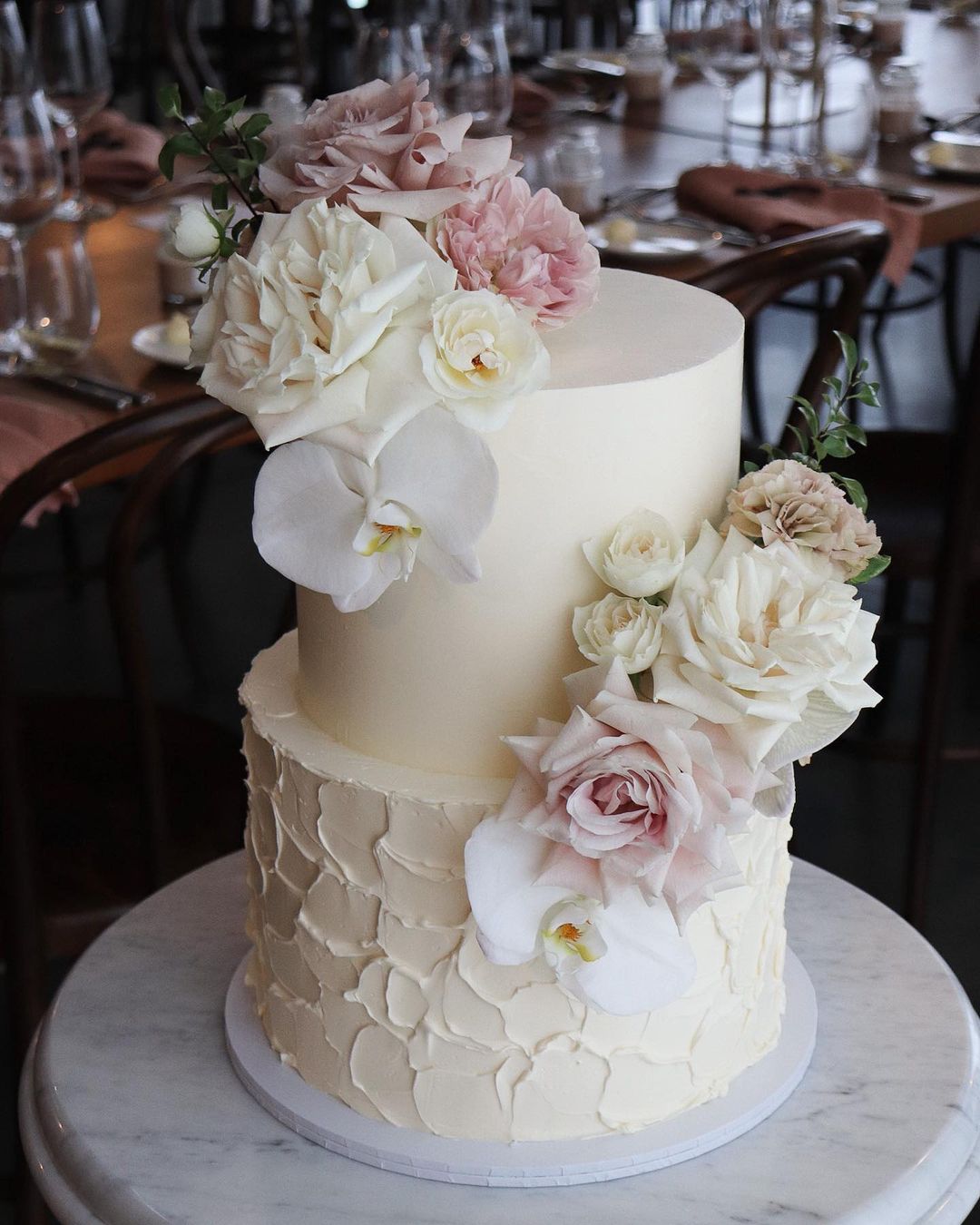 elegant white buttercream wedding cake with white and pink roses via milkandhoney.cakecreative