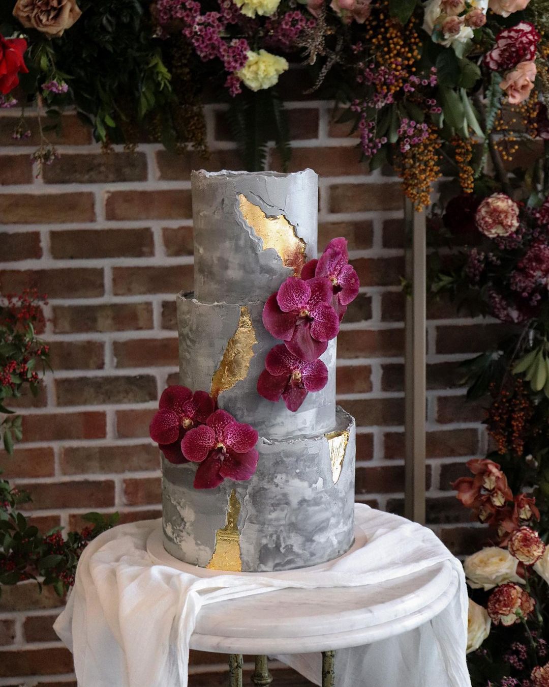 grey marble modern wedding cake with gold foil and purple flowers via milkandhoney.cakecreative