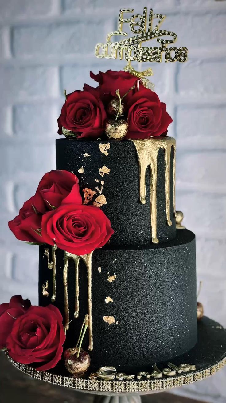 modern black matte forested two tier drip wedding cake with red roses